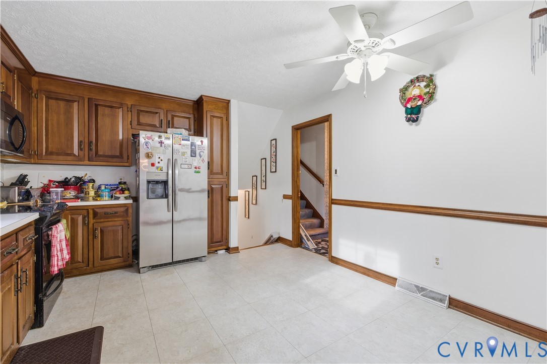 12508 Percival Street Chester, VA 23831 - Photo 11 of 30 a view of a storage & utility room with refrigerator and ceiling fan