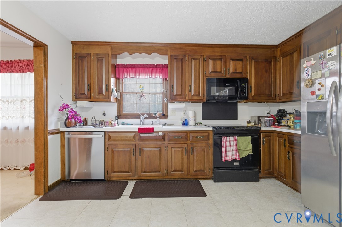 12508 Percival Street Chester, VA 23831 - Photo 14 of 30 a kitchen with granite countertop a stove top oven microwave and cabinets