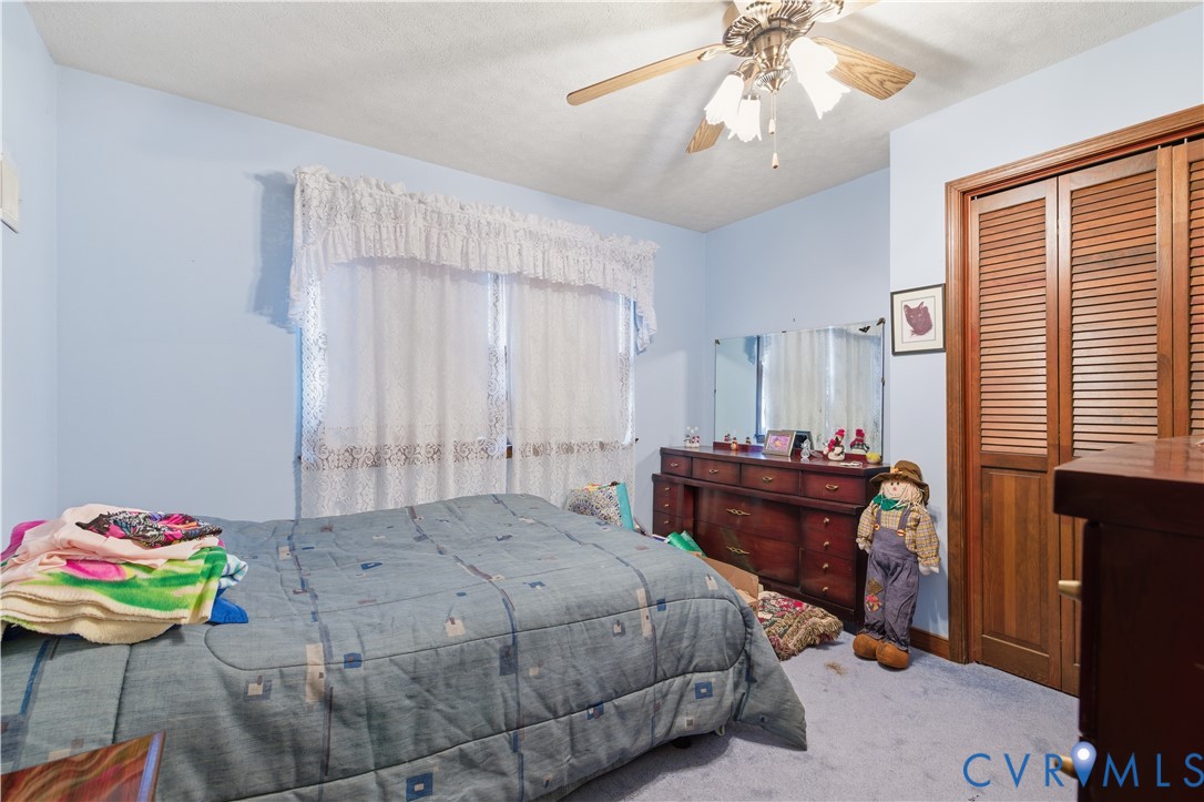12508 Percival Street Chester, VA 23831 - Photo 15 of 30 a bedroom with a bed and a table