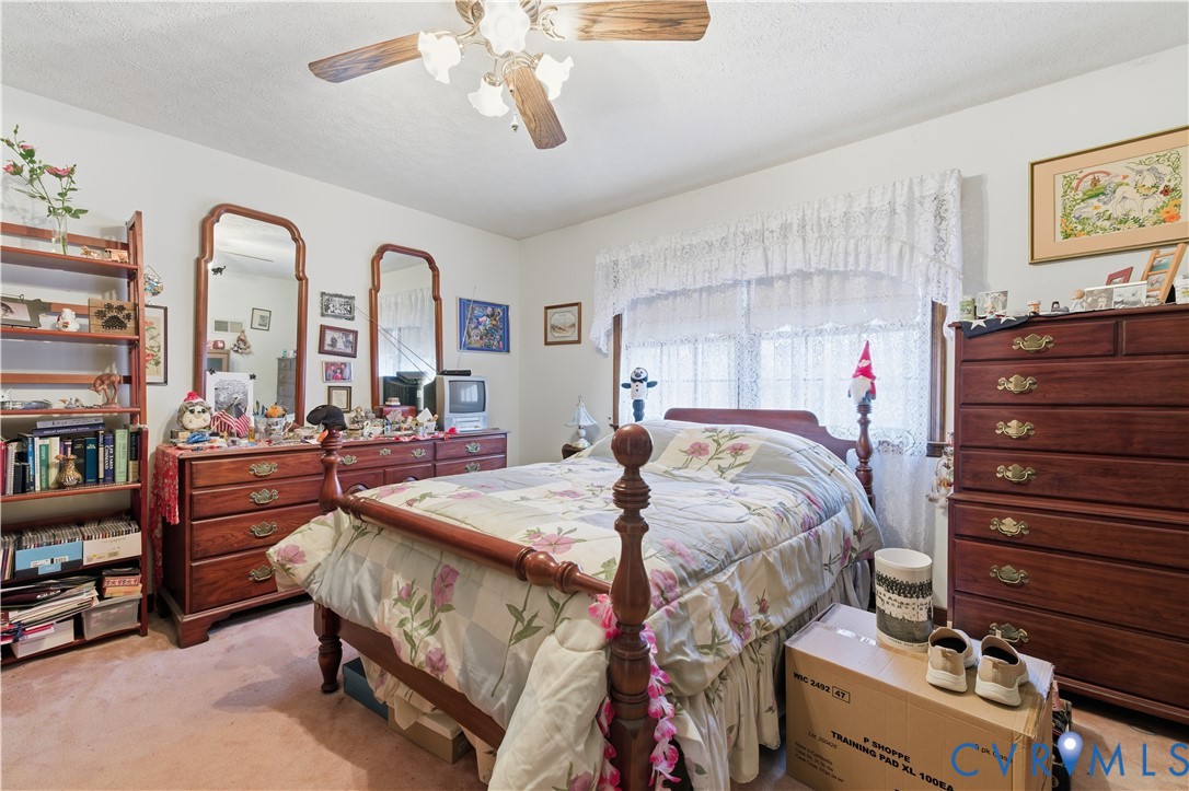 12508 Percival Street Chester, VA 23831 - Photo 23 of 30 a bed room with a bed and a chandelier