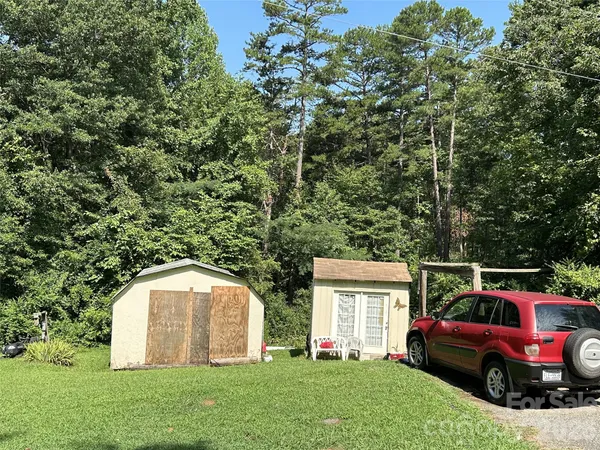 a view of backyard with deck and garden
