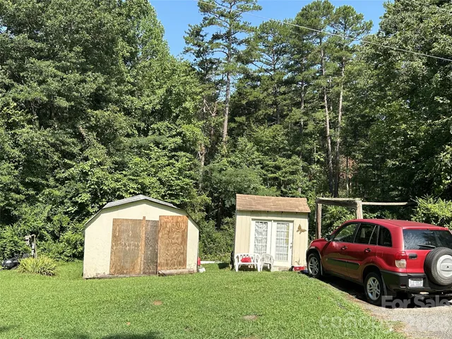 a view of backyard with deck and garden