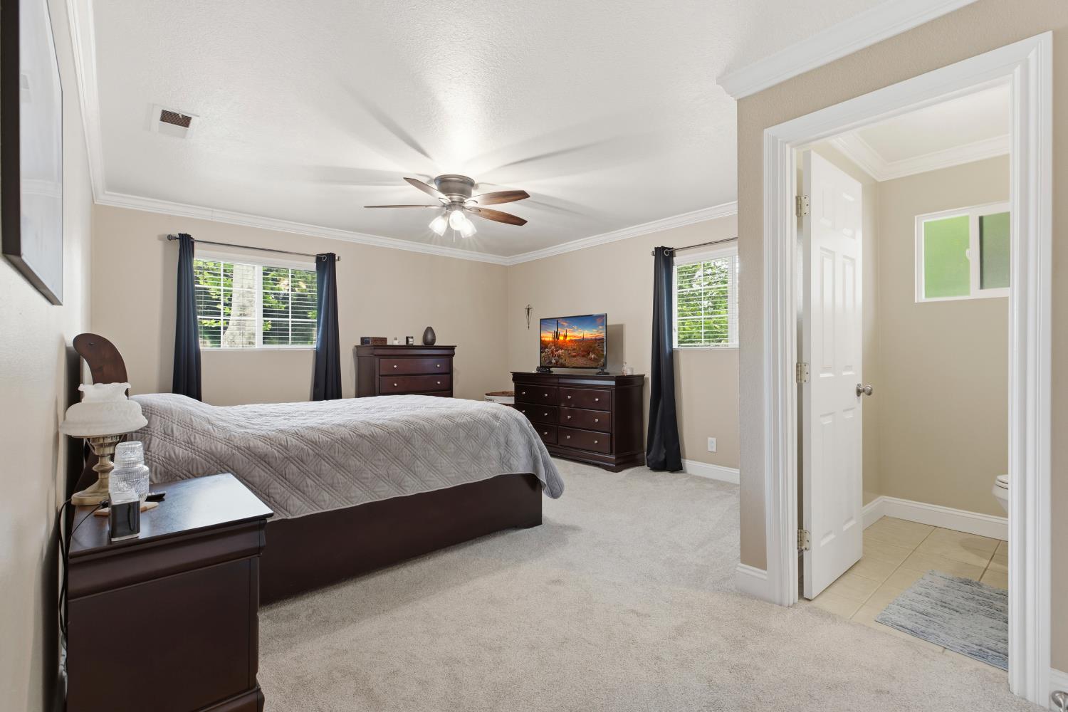 550 Bell Street Turlock, CA 95380 - Photo 18 of 36 a bedroom with a large bed and ceiling fan