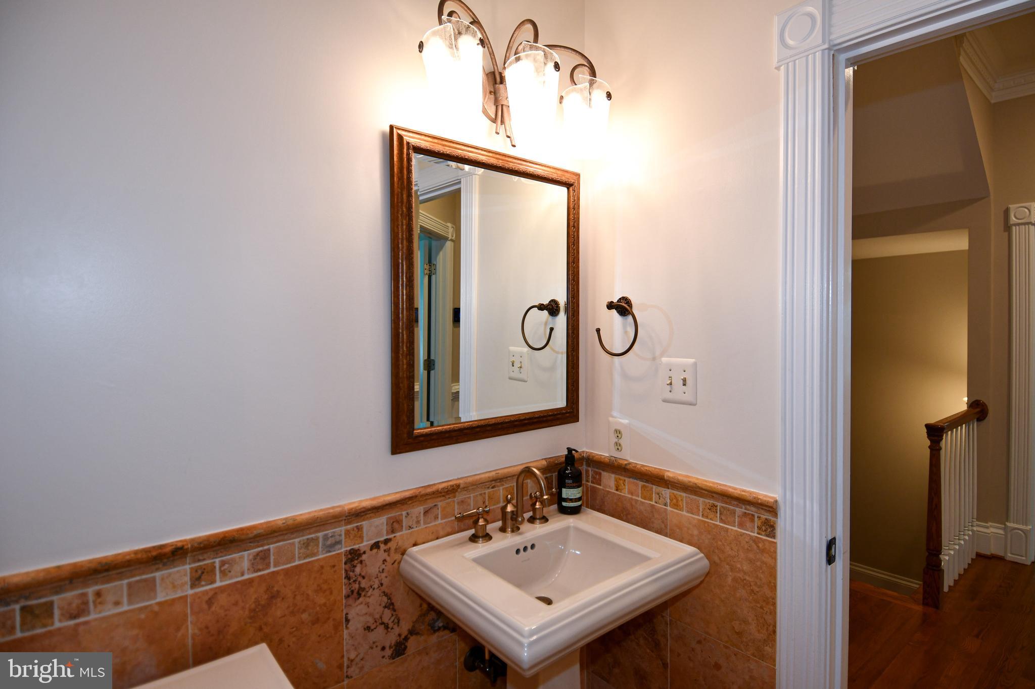 7808 Southdown Road Alexandria, VA 22308 - Photo 53 of 99 a bathroom with a sink a mirror and a shower