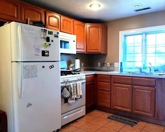 a white refrigerator freezer sitting inside of a kitchen