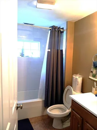 a bathroom with a toilet a sink and a shower