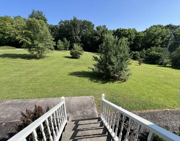 a view of a deck with a yard