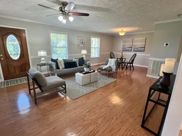 a living room with furniture dining table and a large window