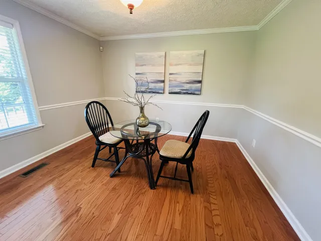 a view of a dining room with furniture and wooden floor