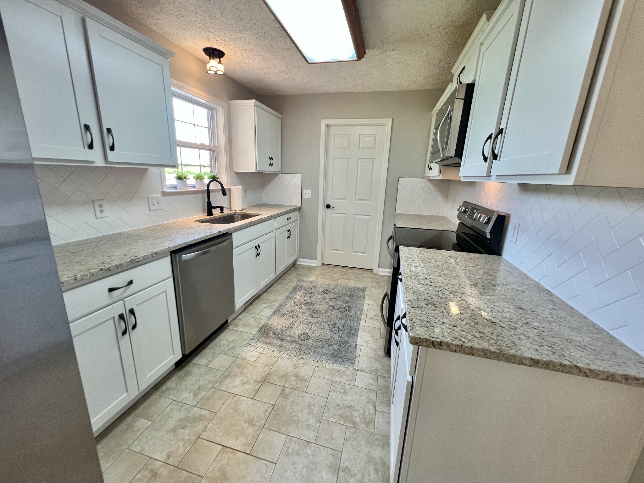 5345 Ashburn Road Springfield, TN 37172 - Photo 26 of 46 a kitchen with stainless steel appliances granite countertop a sink and a stove
