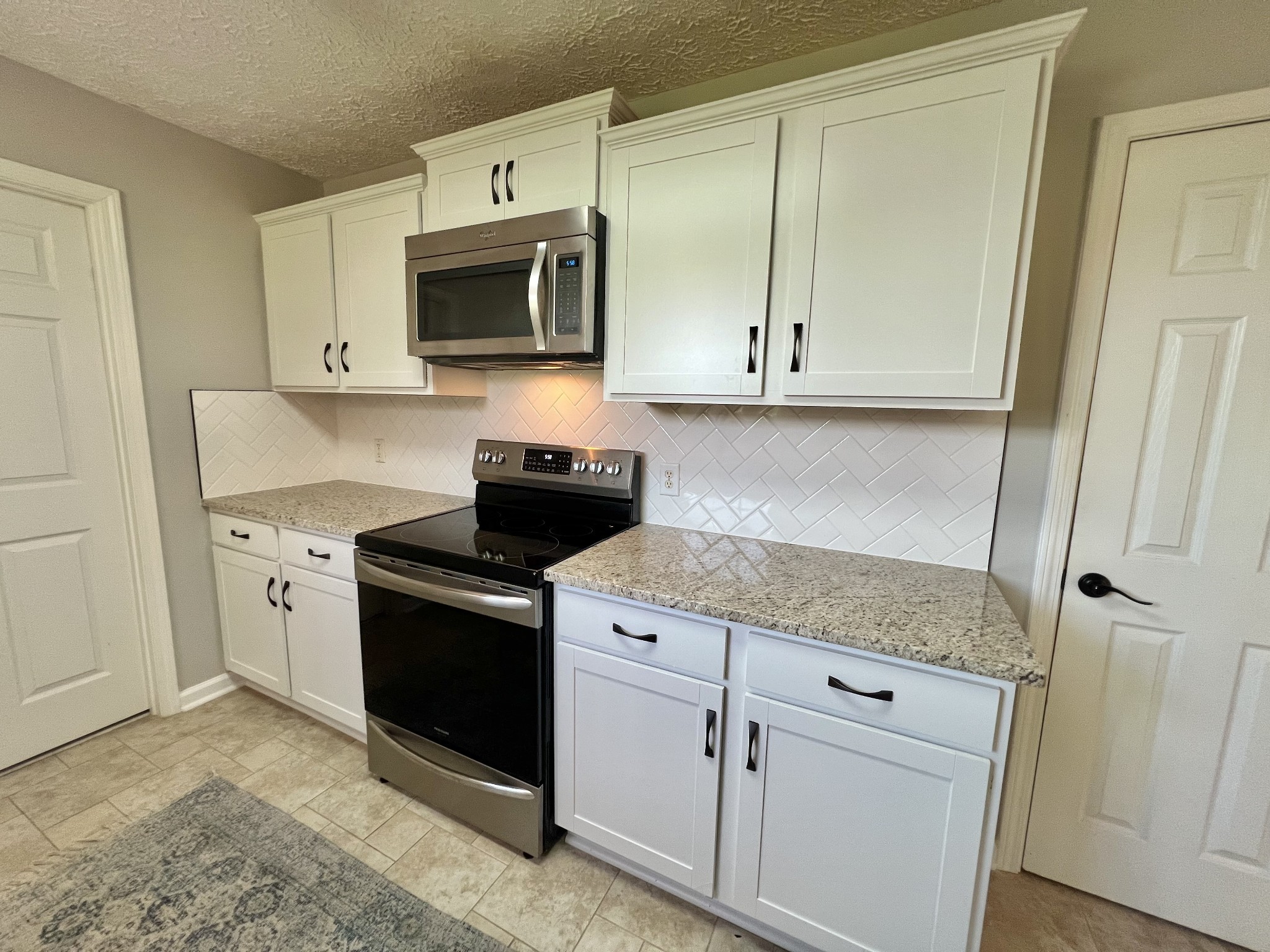 5345 Ashburn Road Springfield, TN 37172 - Photo 30 of 46 a kitchen with stainless steel appliances granite countertop a stove and a microwave