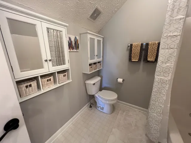 a white toilet sitting next to a bathroom sink