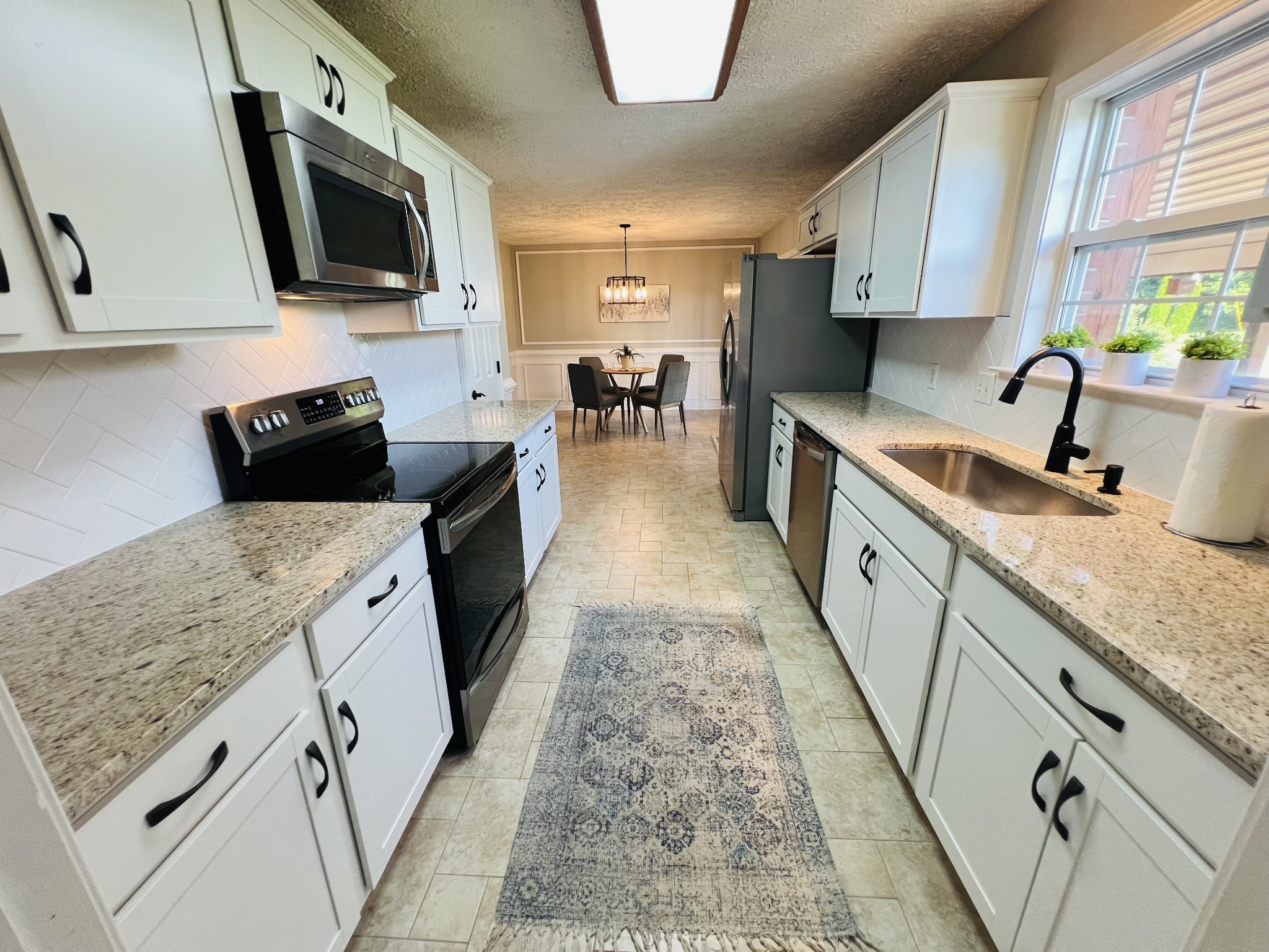 5345 Ashburn Road Springfield, TN 37172 - Photo 7 of 46 a kitchen with granite countertop a sink a counter top space appliances and cabinets