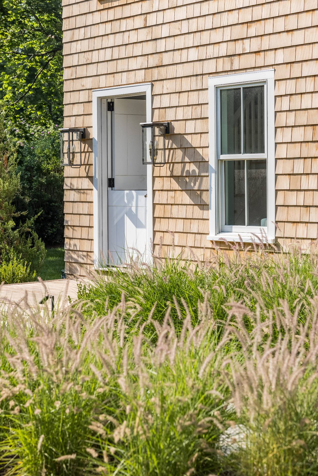 110 Ferry Road Sag Harbor, NY 11963 - Photo 9 of 17 a front view of a house with a garden