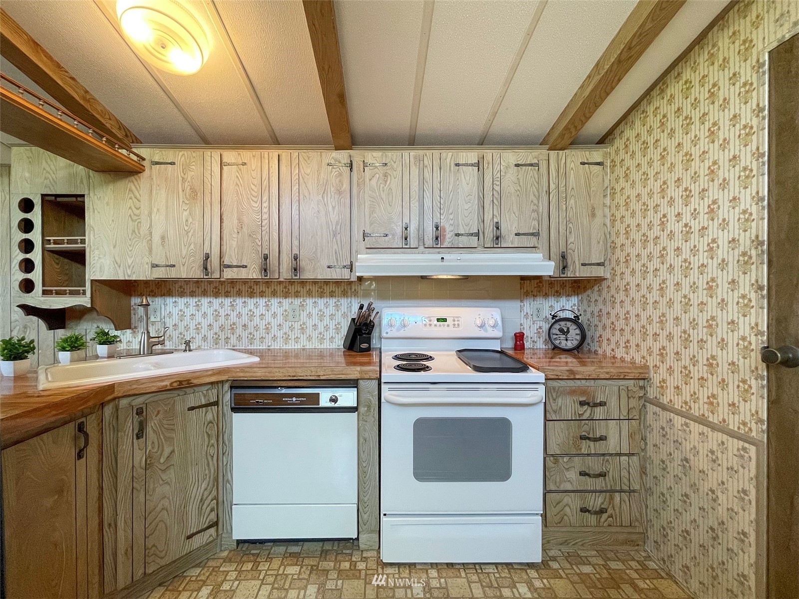 141 Streit Road Sequim, WA 98382 - Photo 15 of 40 a kitchen with a sink stove and cabinets