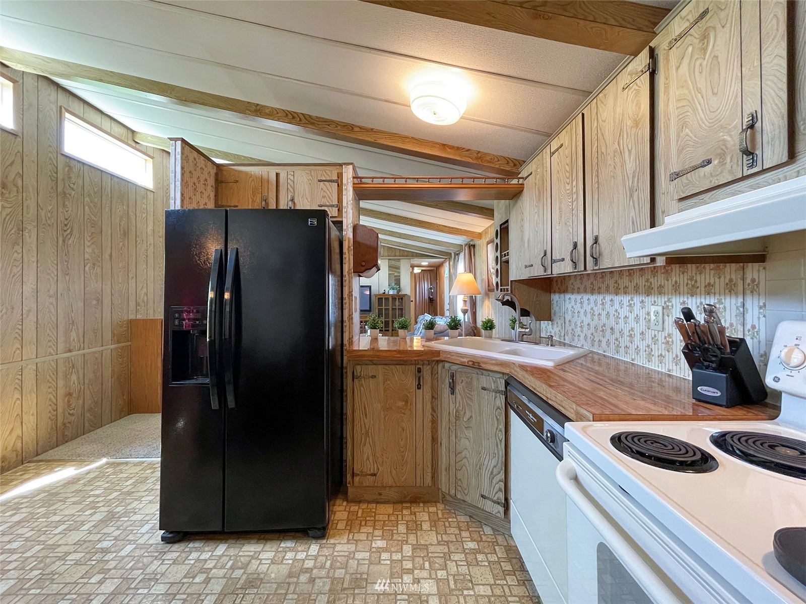 141 Streit Road Sequim, WA 98382 - Photo 16 of 40 a kitchen with a refrigerator and a sink