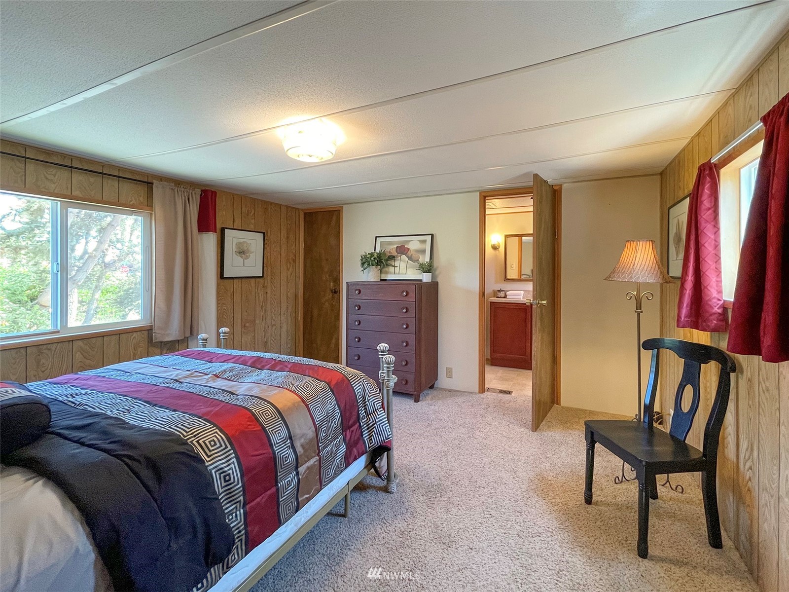 141 Streit Road Sequim, WA 98382 - Photo 18 of 40 a bedroom with a bed and a chair