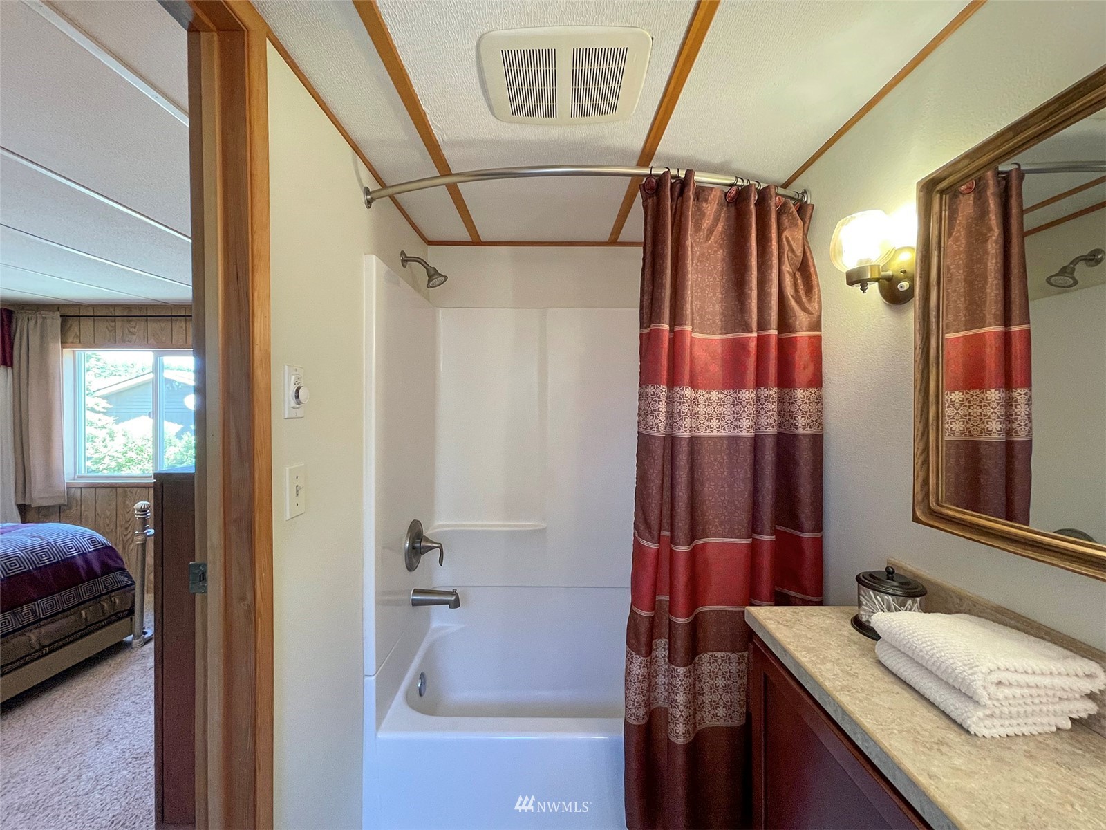 141 Streit Road Sequim, WA 98382 - Photo 20 of 40 a bathroom with a granite countertop sink a mirror and shower