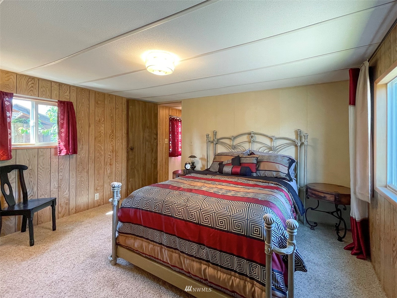 141 Streit Road Sequim, WA 98382 - Photo 22 of 40 a bedroom with a bed and a chandelier