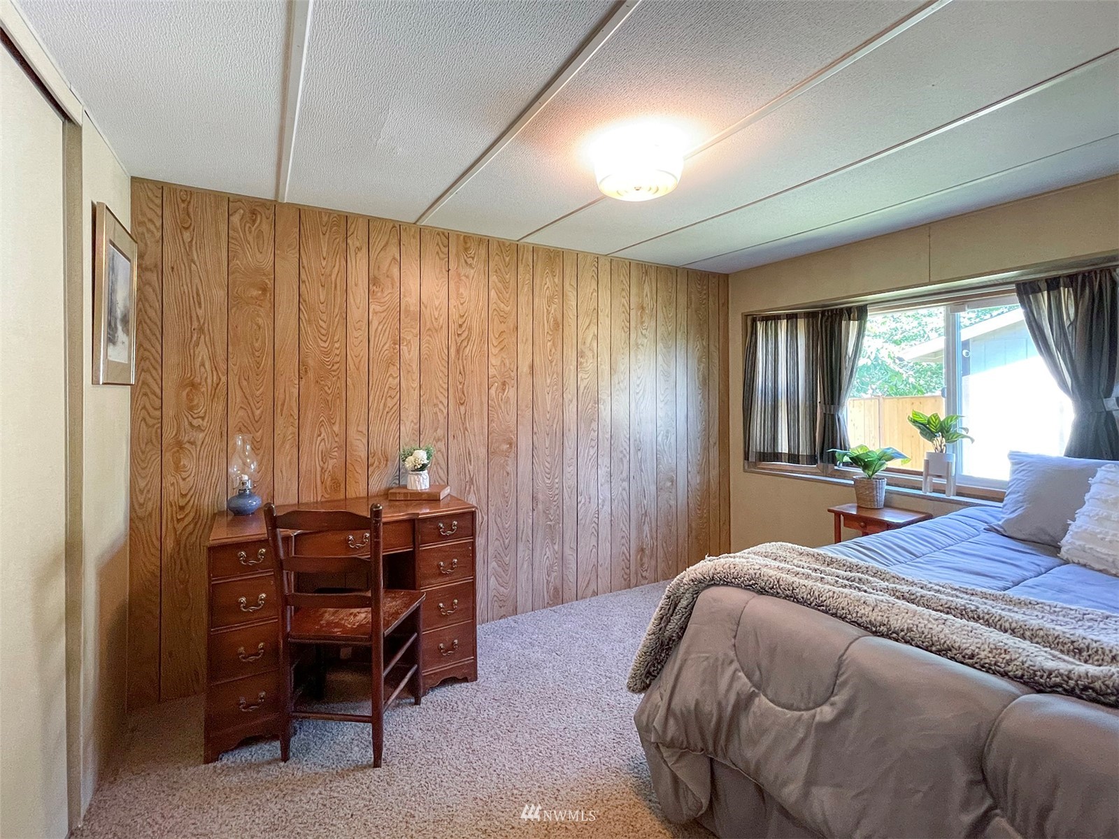 141 Streit Road Sequim, WA 98382 - Photo 28 of 40 a bedroom with a bed and a chandelier