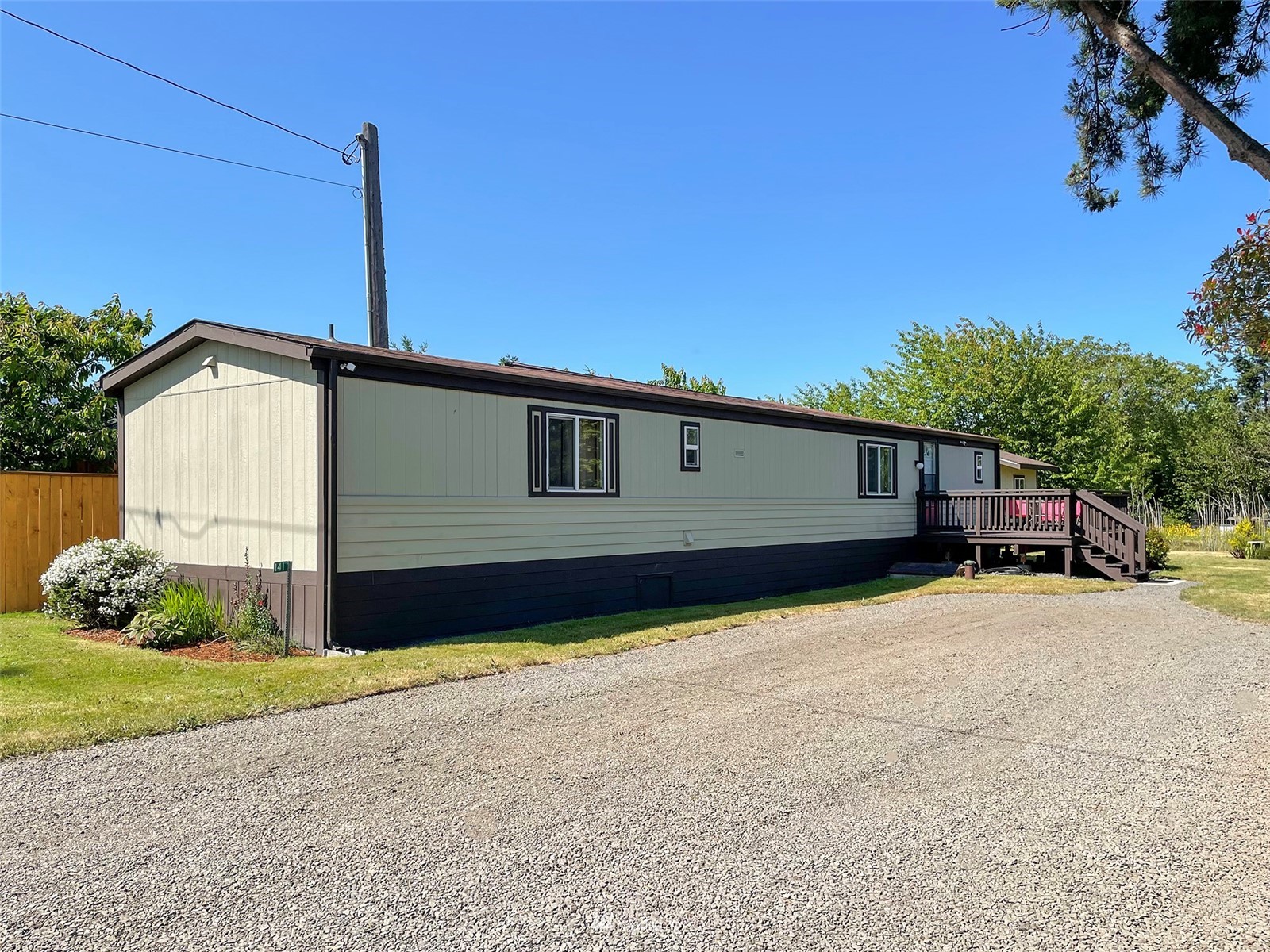 141 Streit Road Sequim, WA 98382 - Photo 5 of 40 a front view of a house with a yard and garage