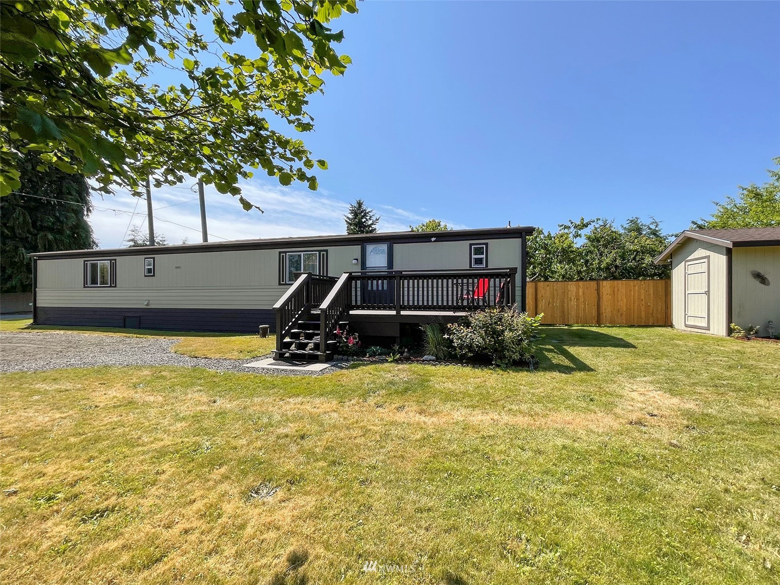 141 Streit Road Sequim, WA 98382 - Photo 7 of 40 a view of a swimming pool with a bench and trees