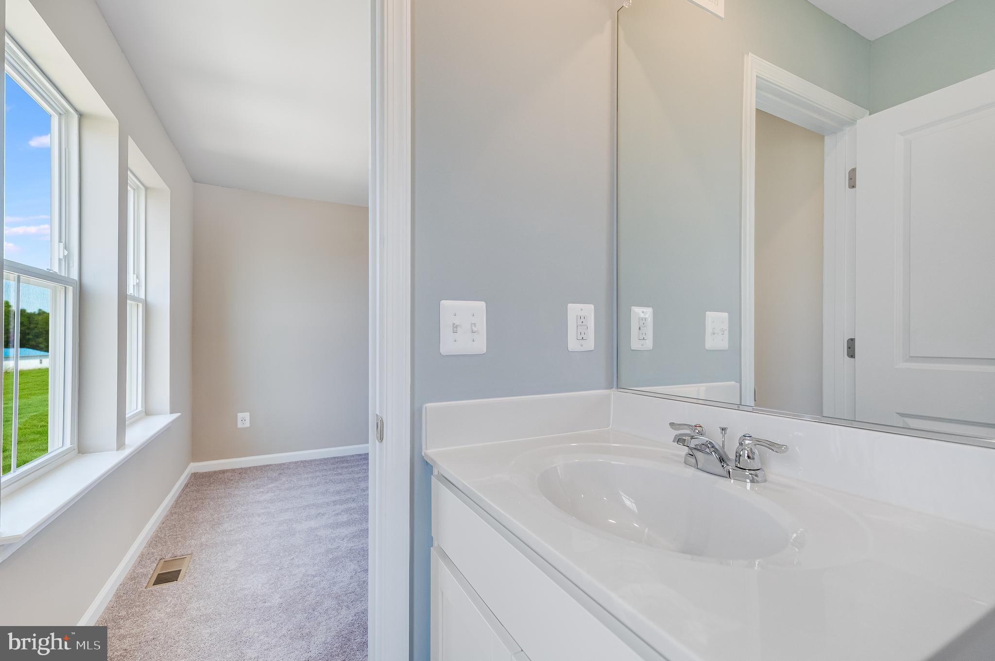 93 Gray Silver Road, Unit HARRIETT Inwood, WV 25428 - Photo 23 of 28 a bathroom with a sink and a large mirror