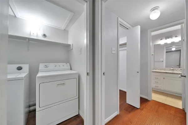 a view of washer and dryer with wooden floor