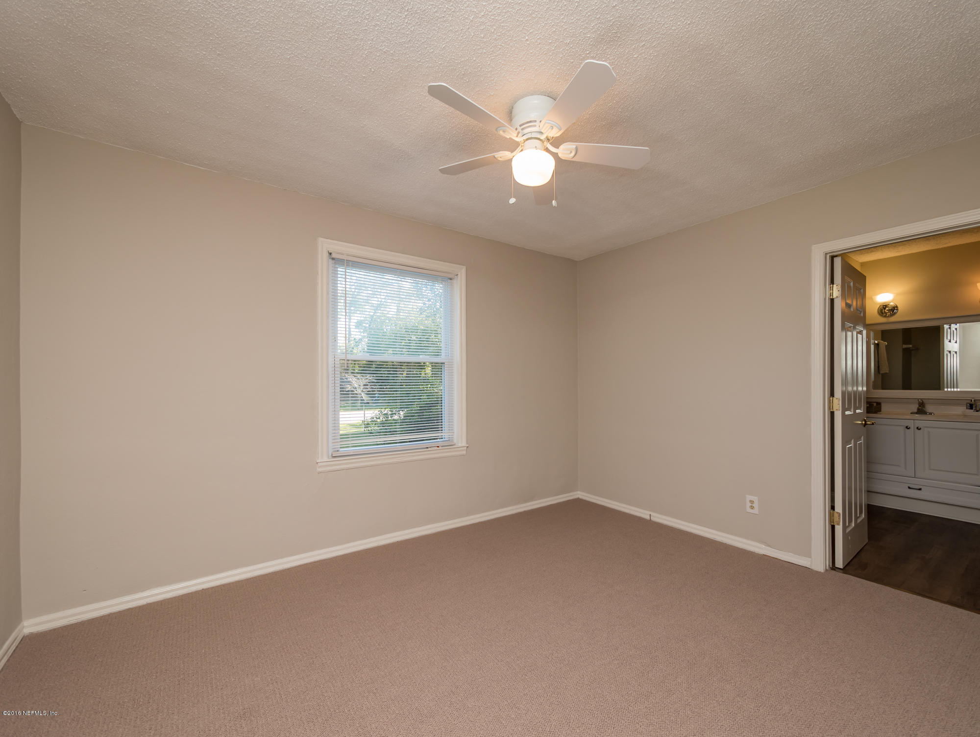 1804 Mayfair Road Jacksonville, FL 32207 - Photo 12 of 26 an empty room with windows and fan