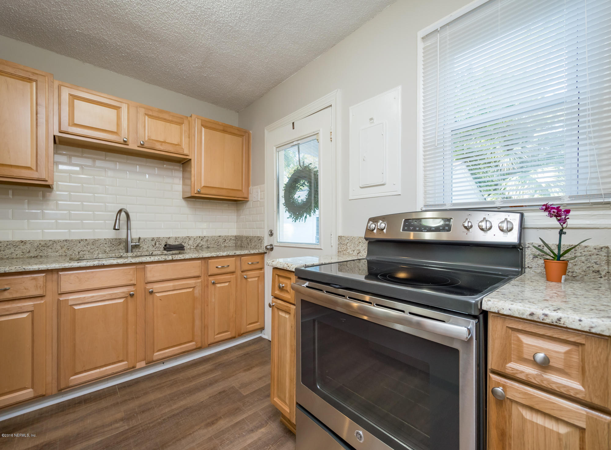 1804 Mayfair Road Jacksonville, FL 32207 - Photo 8 of 26 a kitchen with granite countertop a stove sink and cabinets