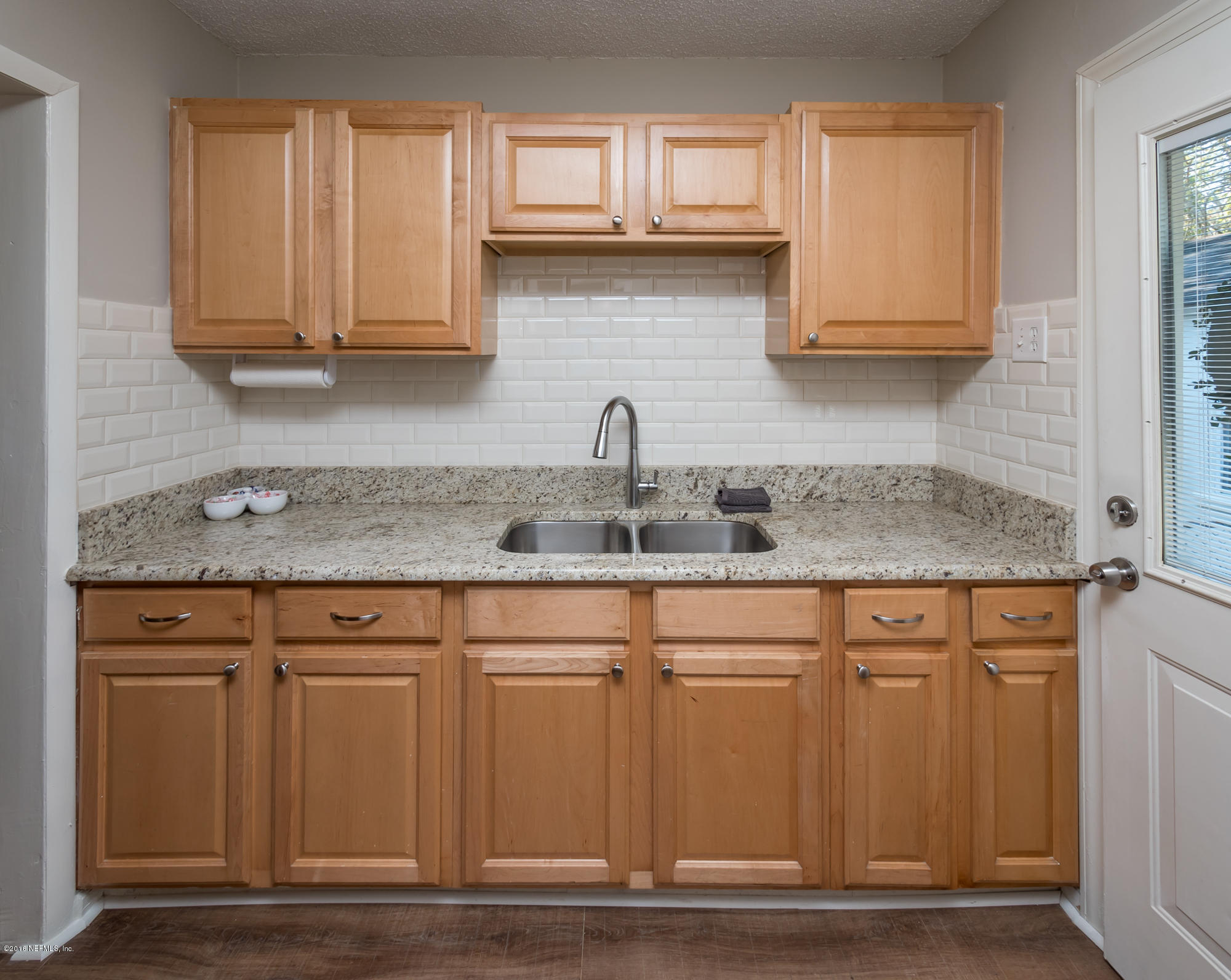 1804 Mayfair Road Jacksonville, FL 32207 - Photo 10 of 26 a kitchen with granite countertop a sink cabinets and stainless steel appliances
