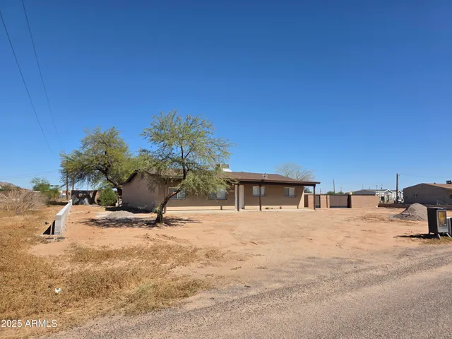 a roof deck with table and chairs under an umbrella