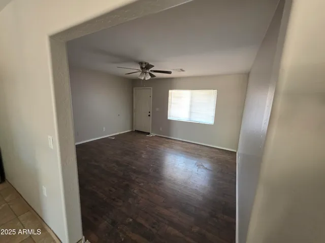 an empty room with windows and closet