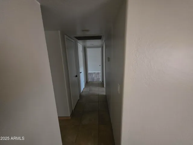 a view of an empty room and wooden floor