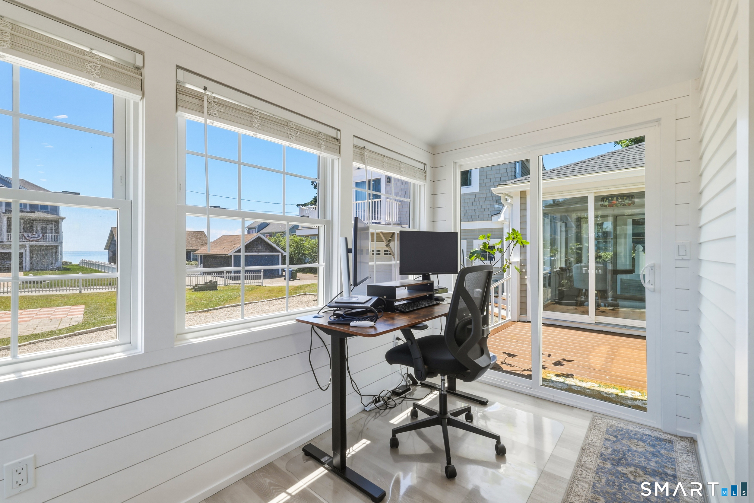 31 Sols Point Road Clinton, CT 06413 - Photo 15 of 40 The owners have carved out a dedicated office nook within the sunroom which offers water views, creating an inspiring workspace.