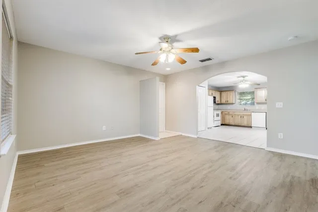 wooden floor in an empty room with a window