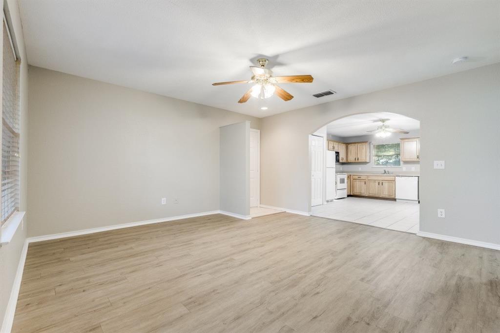 204 Gerrish Street McKinney, TX 75069 - Photo 4 of 12 wooden floor in an empty room with a window