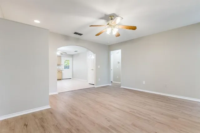 wooden floor in an empty room with a window