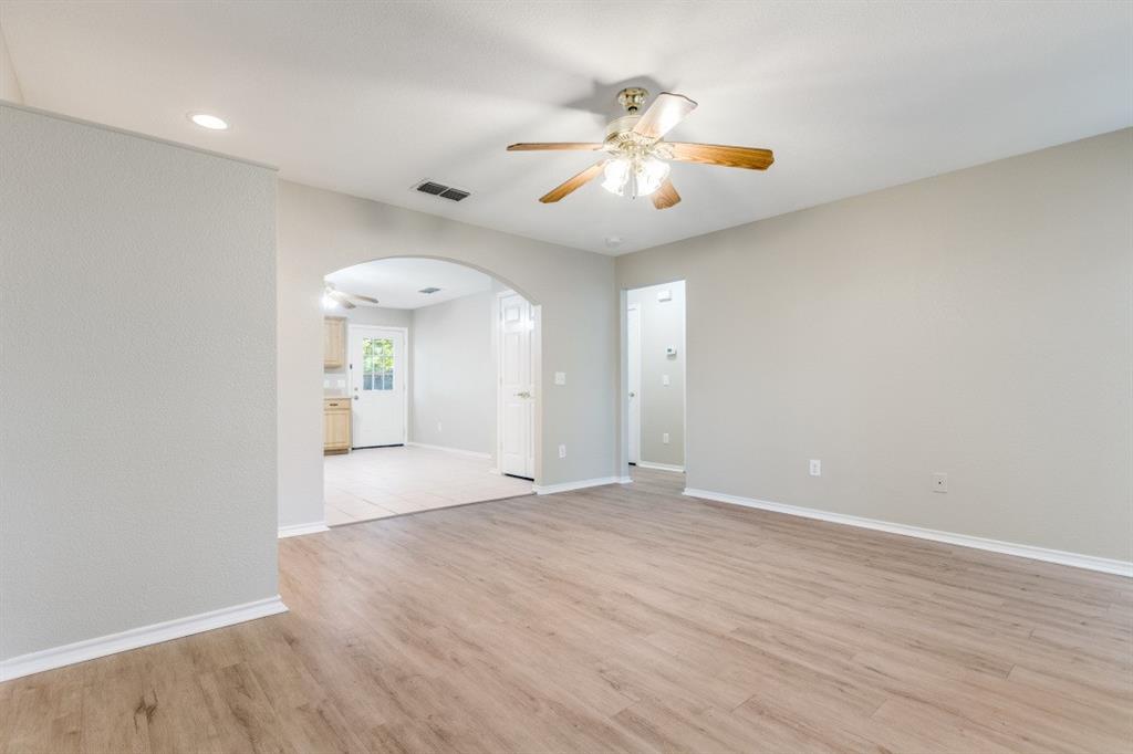 204 Gerrish Street McKinney, TX 75069 - Photo 5 of 12 wooden floor in an empty room with a window