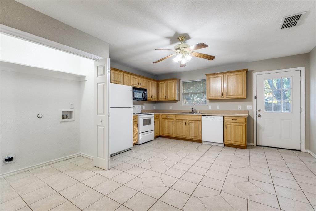204 Gerrish Street McKinney, TX 75069 - Photo 7 of 12 a kitchen with a cabinets a sink stainless steel appliances and cabinets