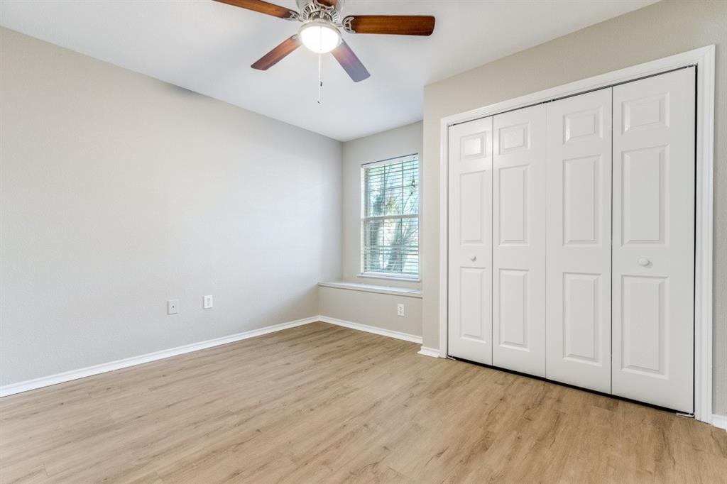 204 Gerrish Street McKinney, TX 75069 - Photo 8 of 12 an empty room with wooden floor chandelier fan and windows