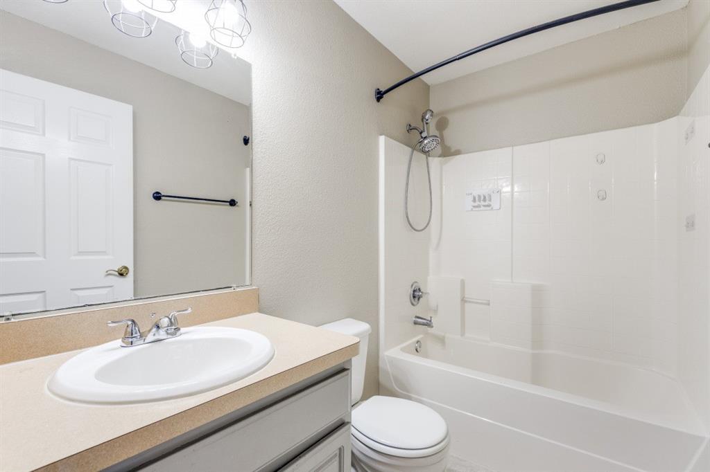 204 Gerrish Street McKinney, TX 75069 - Photo 10 of 12 a bathroom with a granite countertop sink toilet mirror and shower