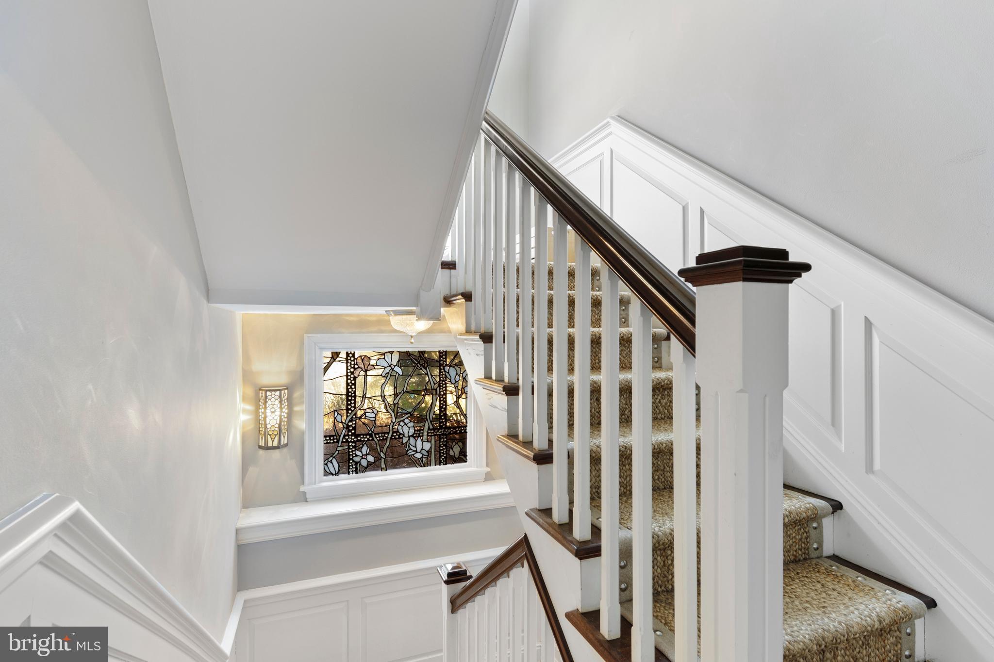720 Brooke Road Wayne, PA 19087 - Photo 38 of 70 a view of staircase with lots of frames on wall and a window