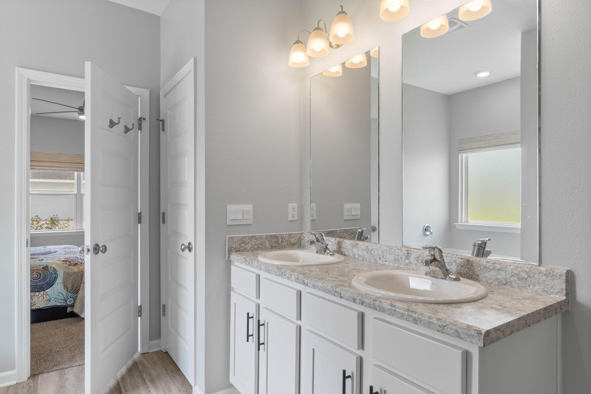 38 Silverthorn Street Freeport, FL 32439 - Photo 23 of 42 a bathroom with a granite countertop sink a light fixture and a mirror