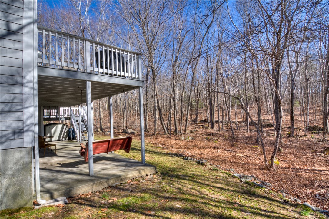 188 Ridge Drive Exeter, RI 02822 - Photo 33 of 40 Deck and Patio w/view of Stone wall and Babbling Brook. Shed under Deck remains.