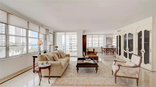 a large white kitchen with stainless steel appliances granite countertop a sink and a stove