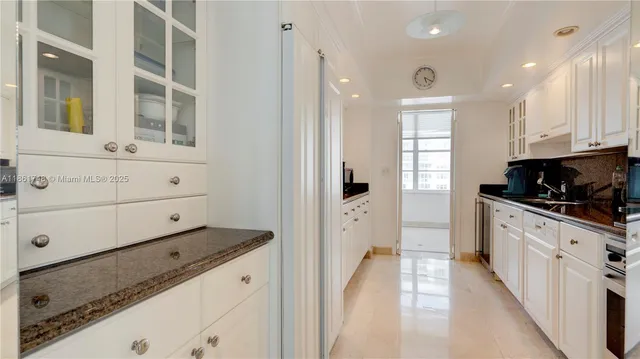 a dining room with furniture a chandelier and wooden floor