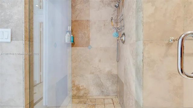 a bathroom with a granite countertop sink a mirror and shower