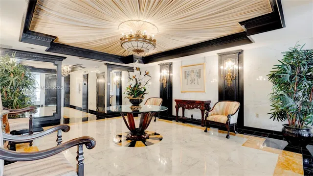 a living room with furniture a large window and potted plants