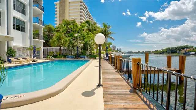 a view of swimming pool with a garden and seating